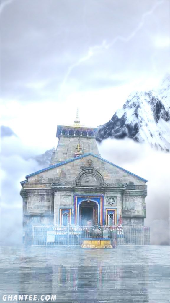 an old building sitting in the middle of water with mountains in the background and fog