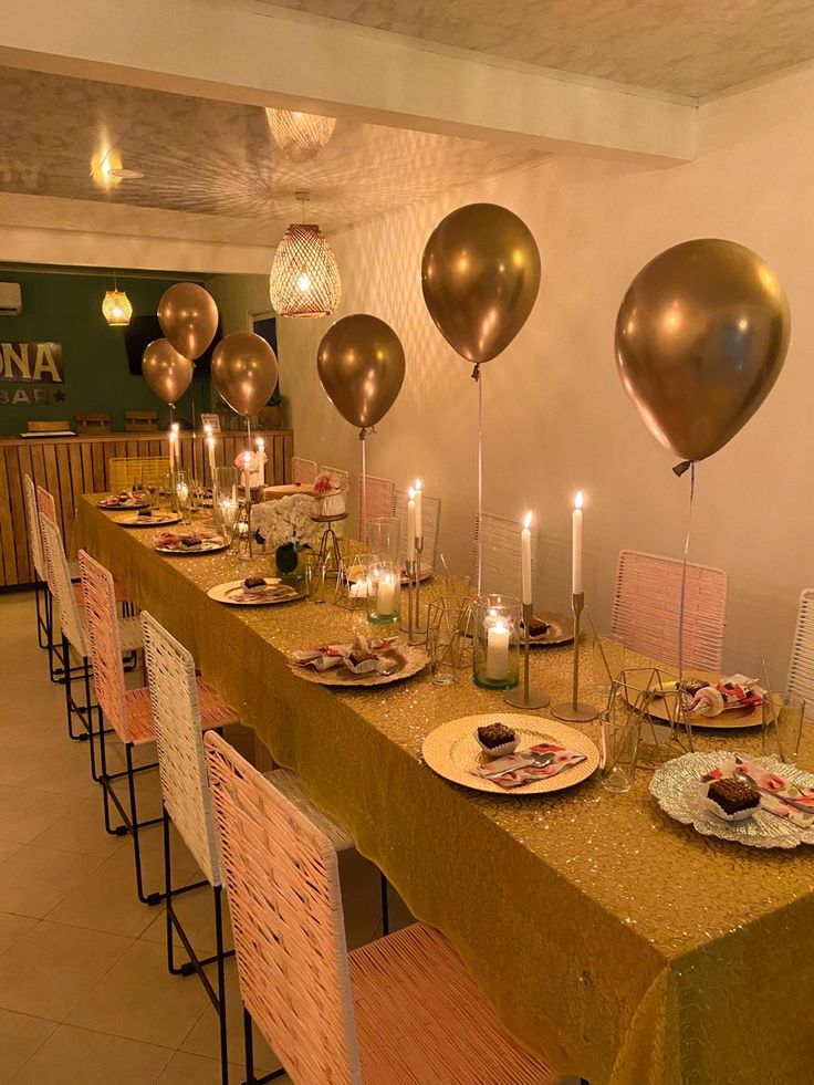 a long table with plates and balloons on it