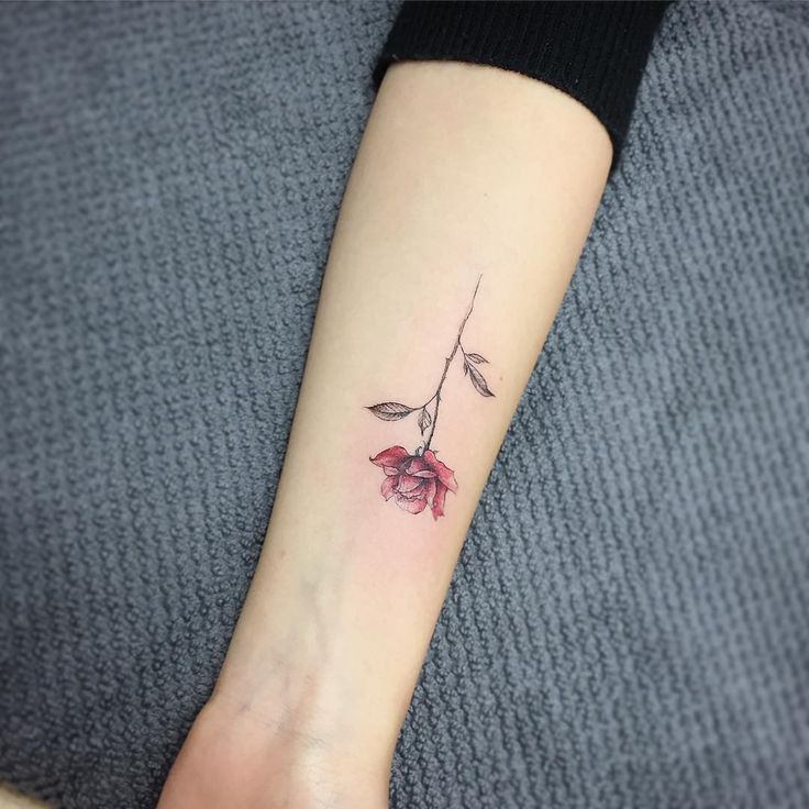 a small flower tattoo on the left forearm and wrist is shown in an instagramtion