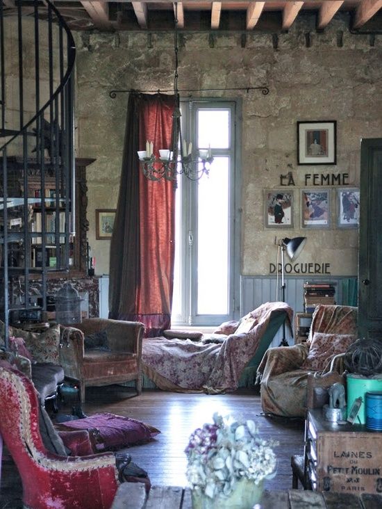 a living room filled with furniture and a spiral staircase leading up to the second floor