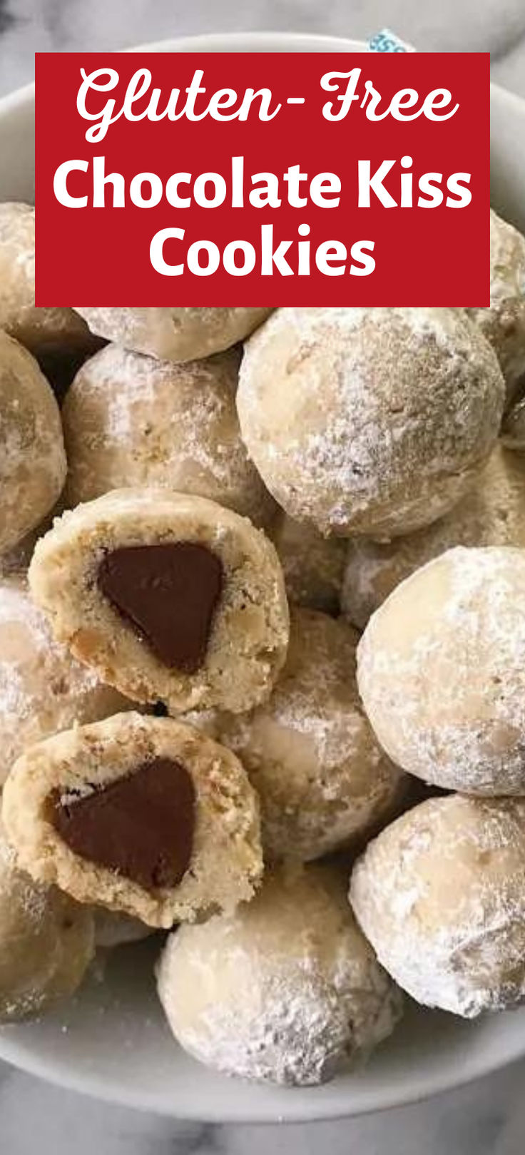 gluten - free chocolate kiss cookies in a white bowl on a marble table