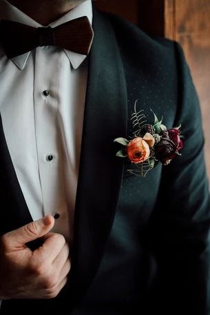 a man in a tuxedo with a boutonniere on his lapel