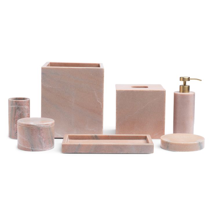 marble bathroom accessories including soap dispenser, toothbrush holder and soap dish