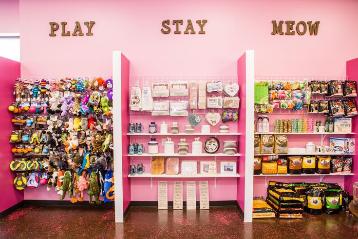 there are two shelves that have toys on them in the store, one is pink and the other is white