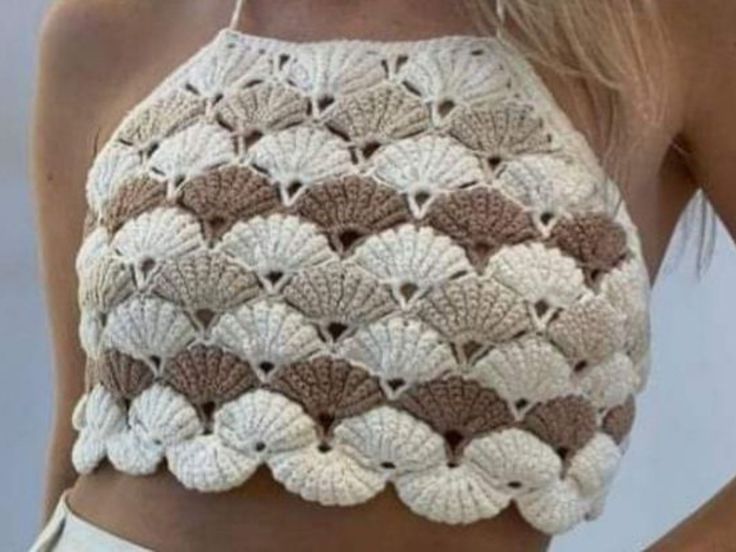 a woman wearing a crocheted crop top