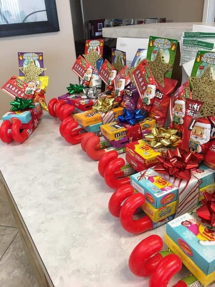 a table topped with lots of different types of gift boxes and presents on top of each other