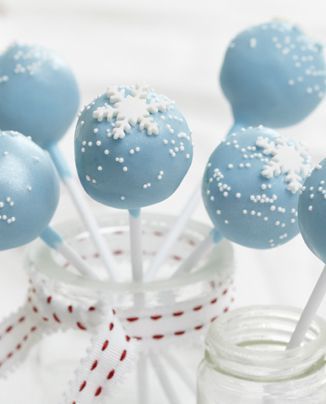 some blue cake pops with white sprinkles on them