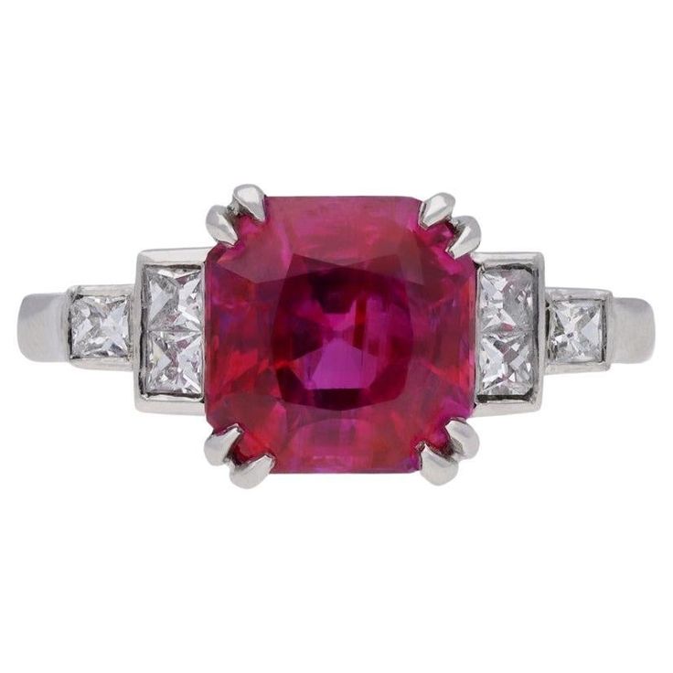 Art deco natural Burmese ruby and diamond ring. Set with an octagonal double brilliant cut natural unenhanced Burmese ruby to centre with an approximate weight of 2.67 carats in an open back double corner claw setting, flanked by six square French cut diamonds in open back rubover settings with an approximate combined weight of 0.30 carats, to a stepped tapered form with a structured openwork gallery, intricate backholing and linear piercing to the central collet, flanked by elegant gently slopi Antique Emerald Ring, Square French, Fancy Diamond Ring, Jewelry Knowledge, Burmese Ruby, Edwardian Ring, Extraordinary Jewelry, Ruby And Diamond Ring, Vintage Jewellery Rings