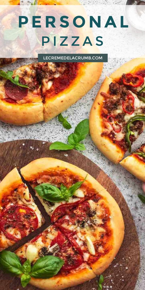 personal pizzas with basil and cheese on wooden platters, including one being cut into slices