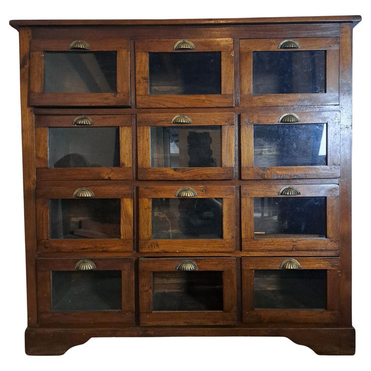 an old wooden cabinet with many glass doors