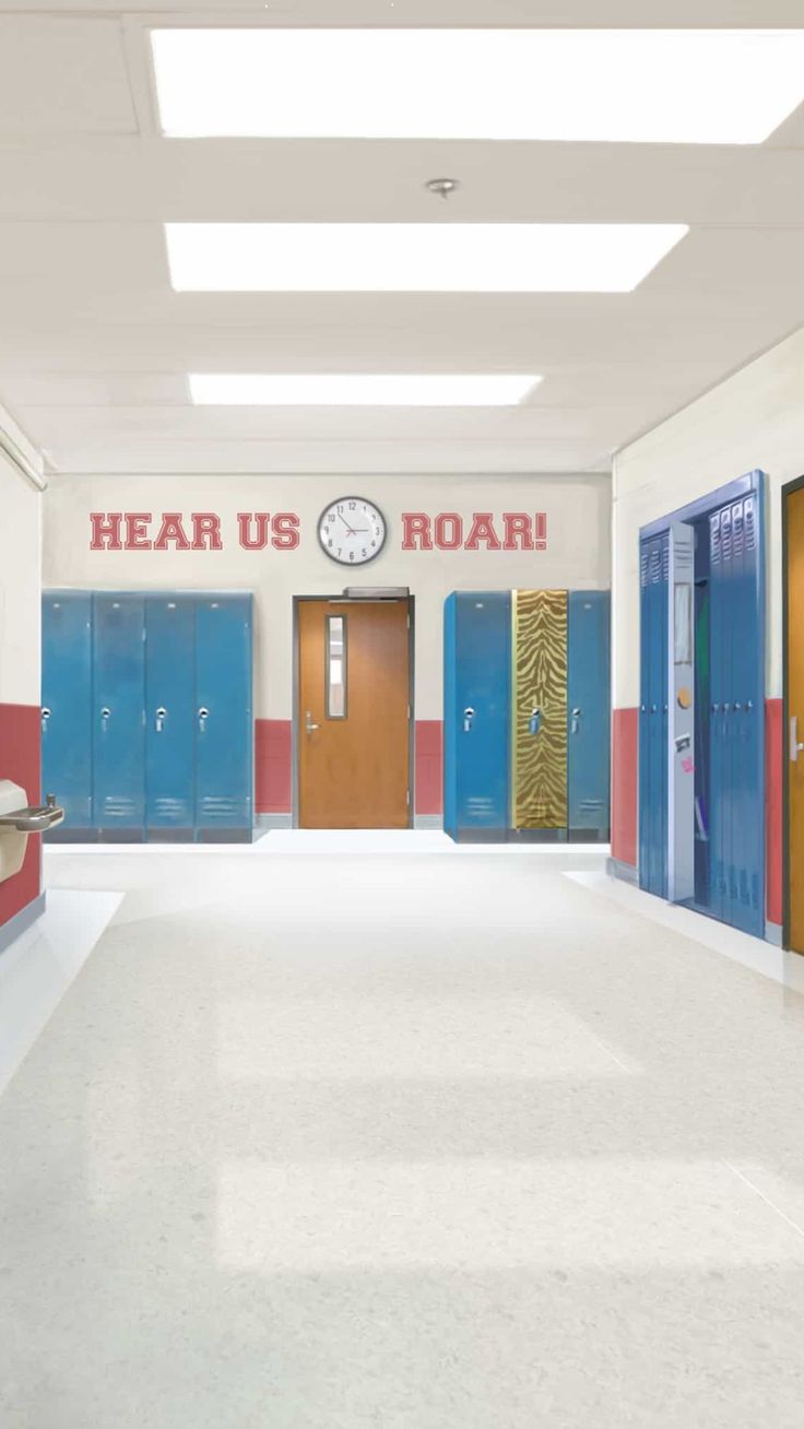 an empty hallway with blue and red lockers on the walls, and a clock mounted to the wall