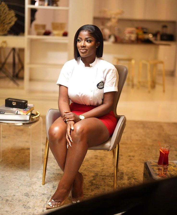 a woman sitting in a chair with her legs crossed