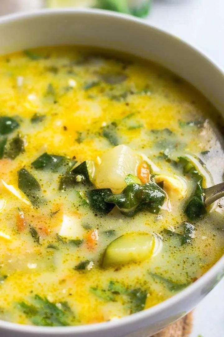 a white bowl filled with soup on top of a table