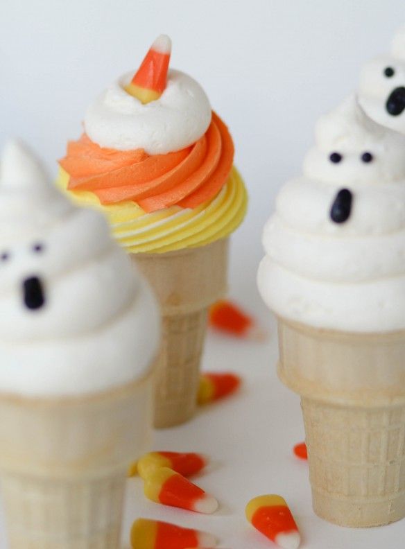 three ice cream cones with frosting and sprinkles on them, all decorated to look like polar bears