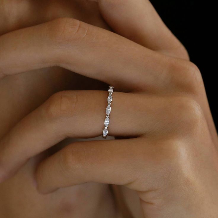 a woman's hand with a diamond ring on her finger