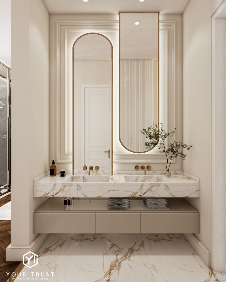 an elegant bathroom with marble counter tops and white walls, along with large mirrors on the wall