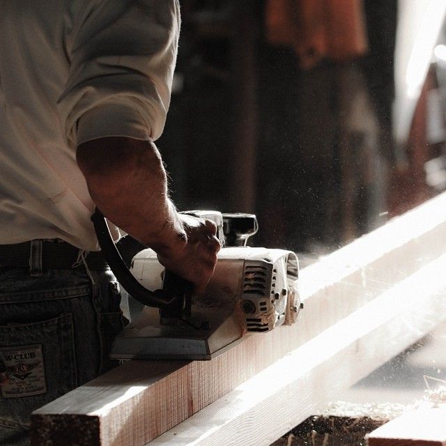 a man using a power tool to cut wood