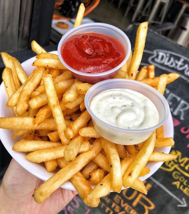 french fries with ketchup and mayonnaise on top