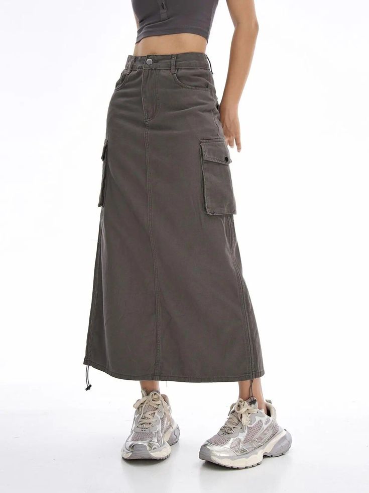 Introducing Our Latest Arrival Elevate your summer wardrobe with our New Cargo Long Skirt – a perfect blend of comfort, style, and versatility. This casual drawstring skirt with pockets is designed for the modern woman who values both fashion and functionality. Key Features Empire Waistline for a flattering fit Mid-Calf Length – the ideal balance of modesty and trendiness No-Nonsense Decoration – embrace simplicity with a clean look A-Line Silhouette for a graceful and timeless appeal Solid Pattern Type – a wardrobe staple that pairs effortlessly Crafted from a blend of Cotton and Polyester for ultimate comfort Non-Stretch Elasticity for a structured and reliable fit Regular Fit – providing comfort without compromising style When to Wear This high-waisted skirt is your go-to choice for cas Gray Lined Skirt, Summer Skirt With Cargo Pockets, Gray Skirt Outfit Casual, Cargo Long Skirt, Drawstring Skirt, Empire Waistline, Skirt With Pockets, Natural Curves, Summer Evening