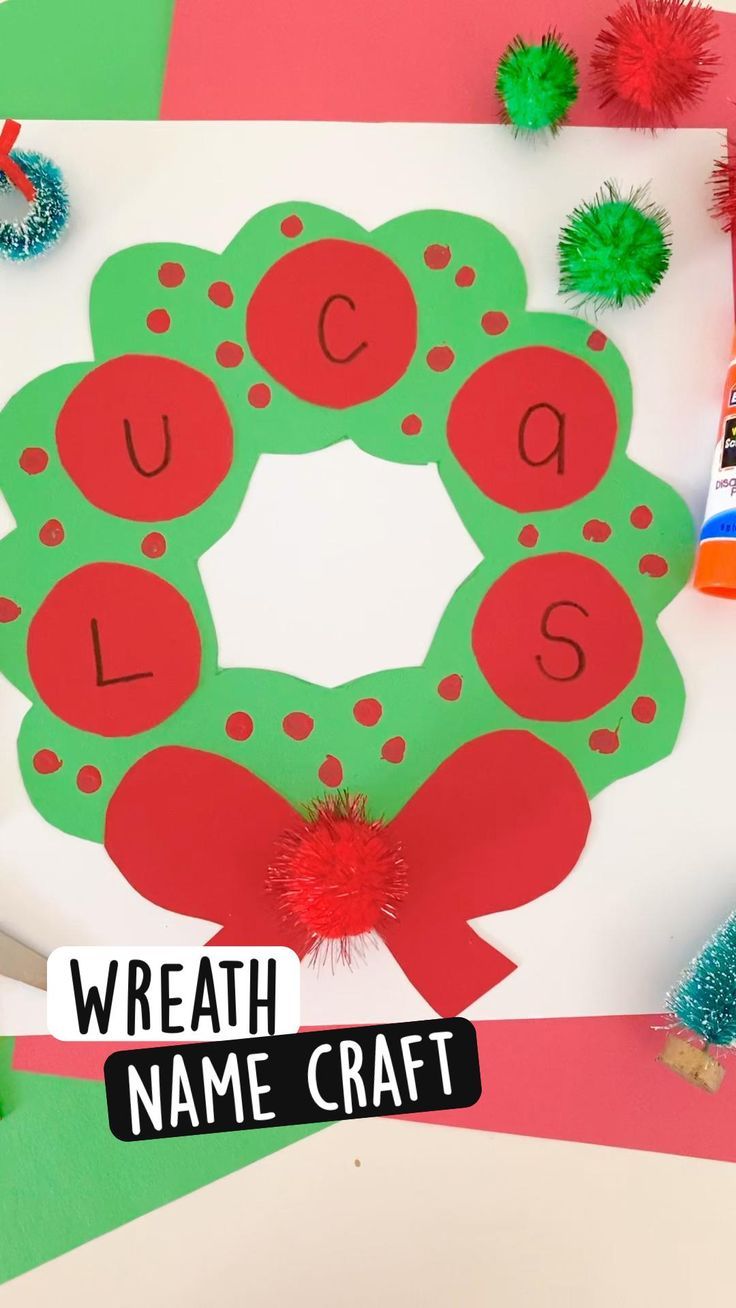 a wreath name craft with pom poms on it