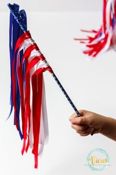 a hand holding an american flag shaped wand