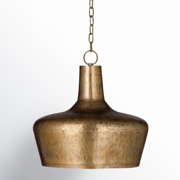 a brass colored light hanging from a chain