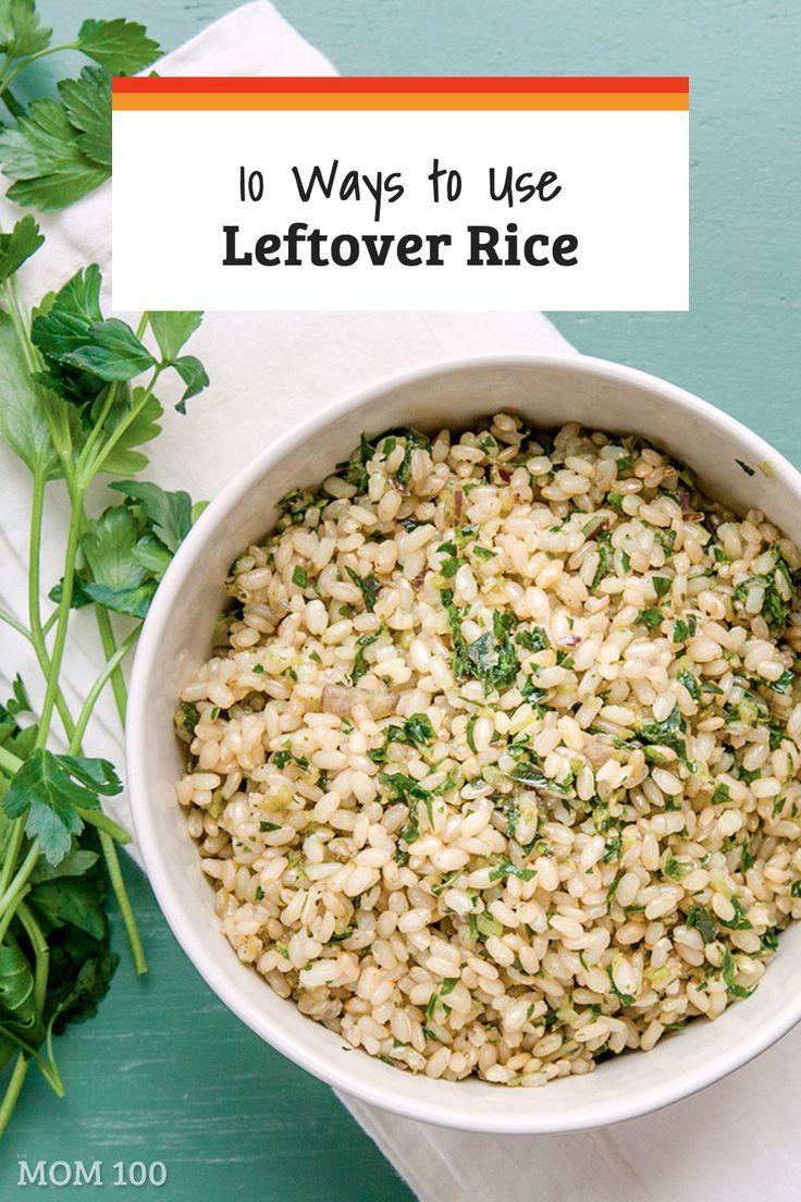 a white bowl filled with brown rice next to some parsley on top of a table