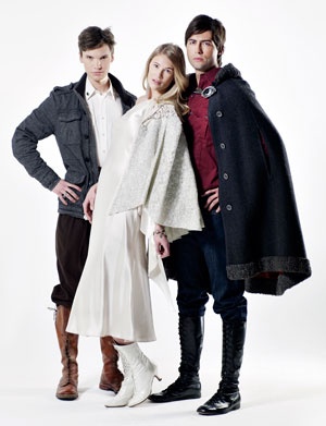 three people standing next to each other in front of a white background wearing coats and boots