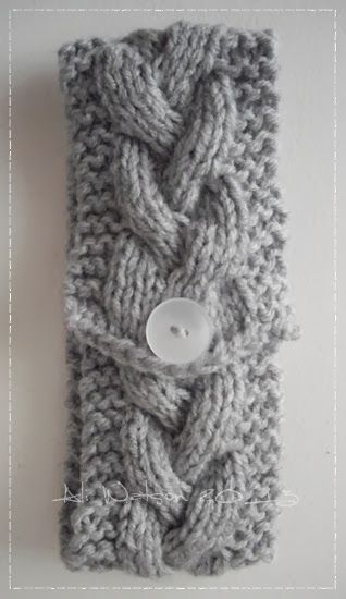 a close up of a knitted cell phone case with buttons on the front and side