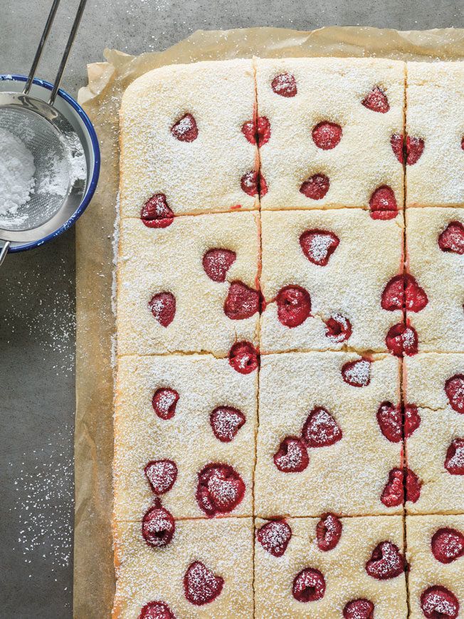 strawberry shortbread squares with sugar on top, ready to be cut into bite sized pieces