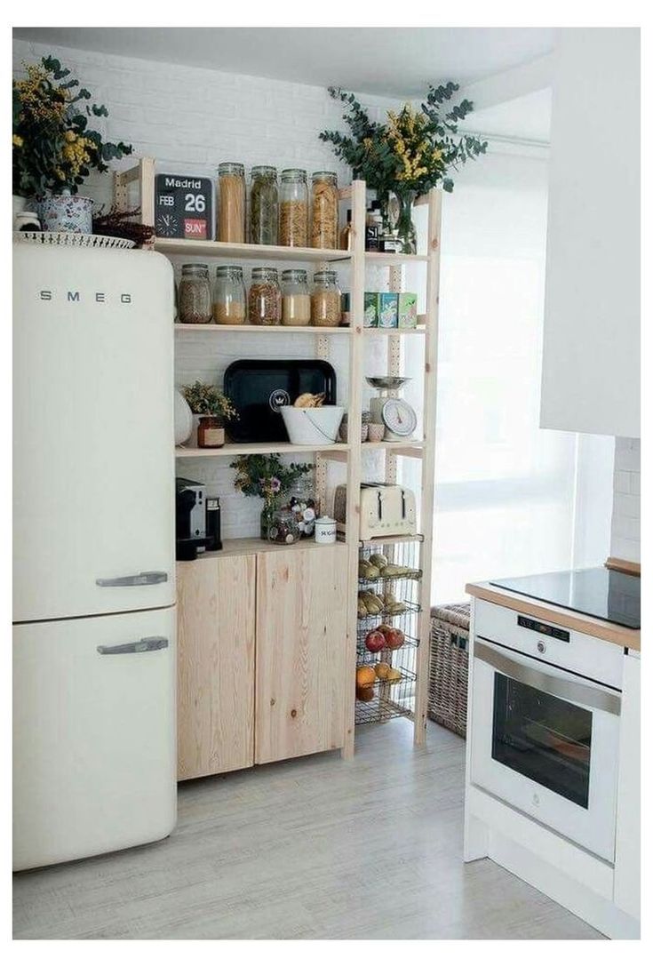 a white refrigerator freezer sitting inside of a kitchen next to a stove top oven