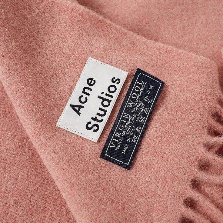 a label on a pink coat that says acne studios