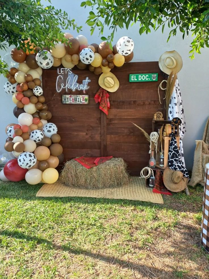 an outdoor display with balloons, hats and decorations