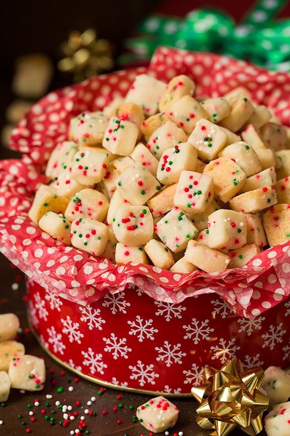 a red bowl filled with white and green sprinkles on top of a table