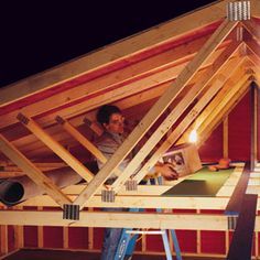 a man is working on the roof of a house with wood framing and insulation tape