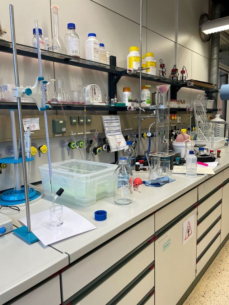 a lab filled with lots of bottles and beakles on top of counter tops next to shelves