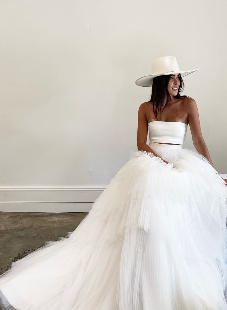 a woman in a white dress and hat