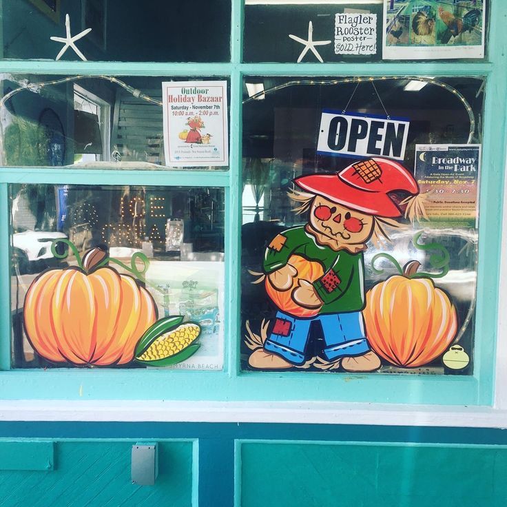 a store window with an image of a man holding a pumpkin