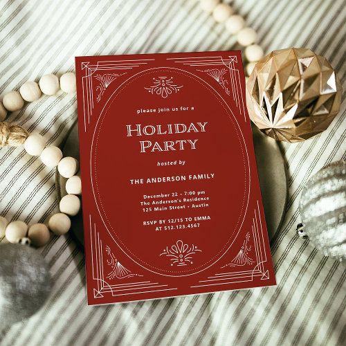 a red holiday party card sitting on top of a bed next to beads and ornaments