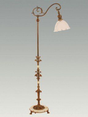 an antique floor lamp with a white shade