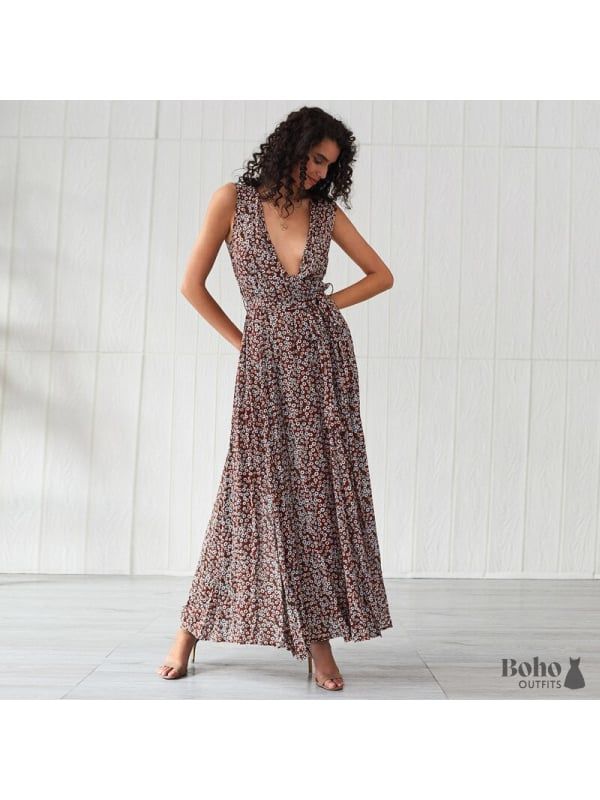 A bohemian dress with a flower motif that is long and stylish. You'll undoubtedly draw attention in this long and stylish bohemian dress! We like how it has a wraparound fit and a matching ribbon belt to help you define your body form. The flowing fabric below the waistline moves to the beat of your steps. The maxi length flatters your figure, and the flowery print gives the outfit a bohemian vibe. This bohemian floral maxi dress for ladies is ideal for a city outing, a special celebration, or a Farewell Dresses, Maxi Floral Dress, Bohemian Dresses Long, Flowing Fabric, Bohemian Maxi, Body Form, Ribbon Belt, Floral Dresses Long, Beach Maxi Dress