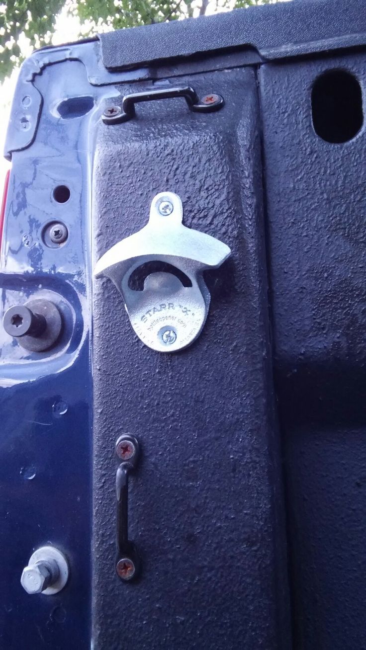 the door handle and latch on a blue truck