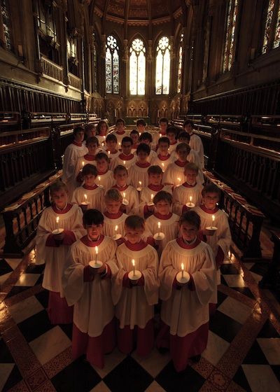 a large group of people holding candles in their hands