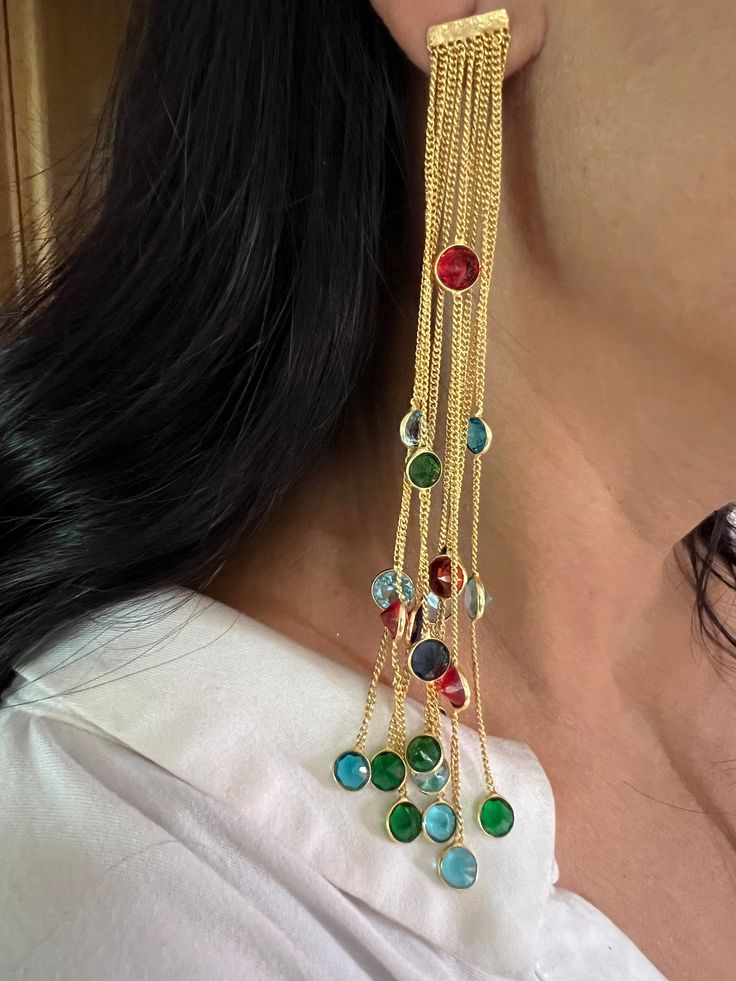 Bollywood Style Long Danglers ♥️ One of a kind. Handcrafted in brass with gold plating and beautiful stones. Pick them up and make a bold stunning statement! Length of earrings: 13 cm. Width of earrings: 2 cm. Weight per pair: 18 grams. Multicolor 17 Jewel Earrings For Party, Gold Jeweled Dangle Earrings, Gold-plated Jeweled Crystal Earrings For Party, Gold Plated Jeweled Crystal Earrings For Party, Gold Brass Crystal Earrings For Party, Jeweled Drop Earrings For Gift, Fusion Style Dangle Chandelier Earrings For Party, Long Drop Brass Linear Earrings For Party, Gold Brass Linear Earrings For Party