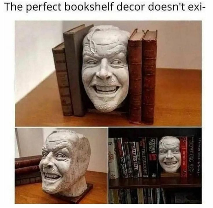 a book shelf with books and a statue of an old man's face