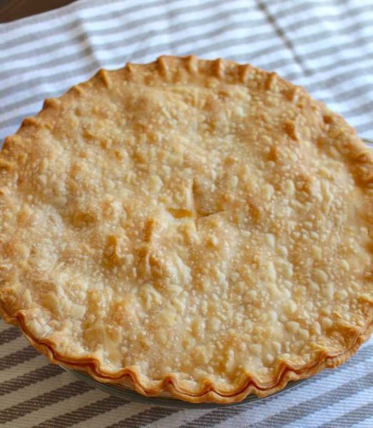 a pie sitting on top of a striped table cloth