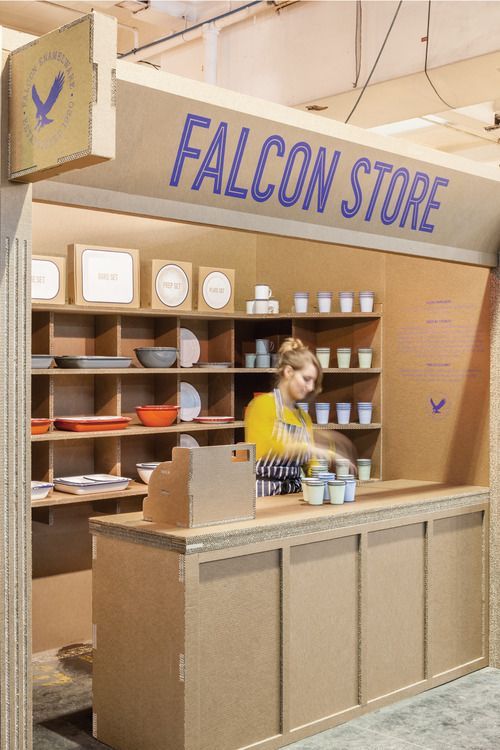 a woman standing behind a counter in a store with lots of items on shelves and the words falcon store above it