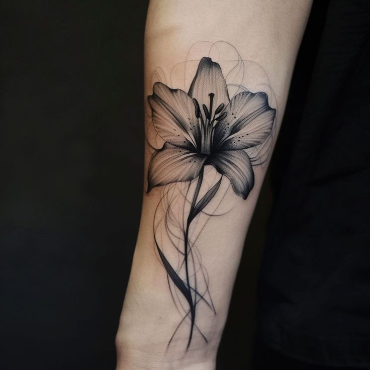 a black and white flower tattoo on the arm