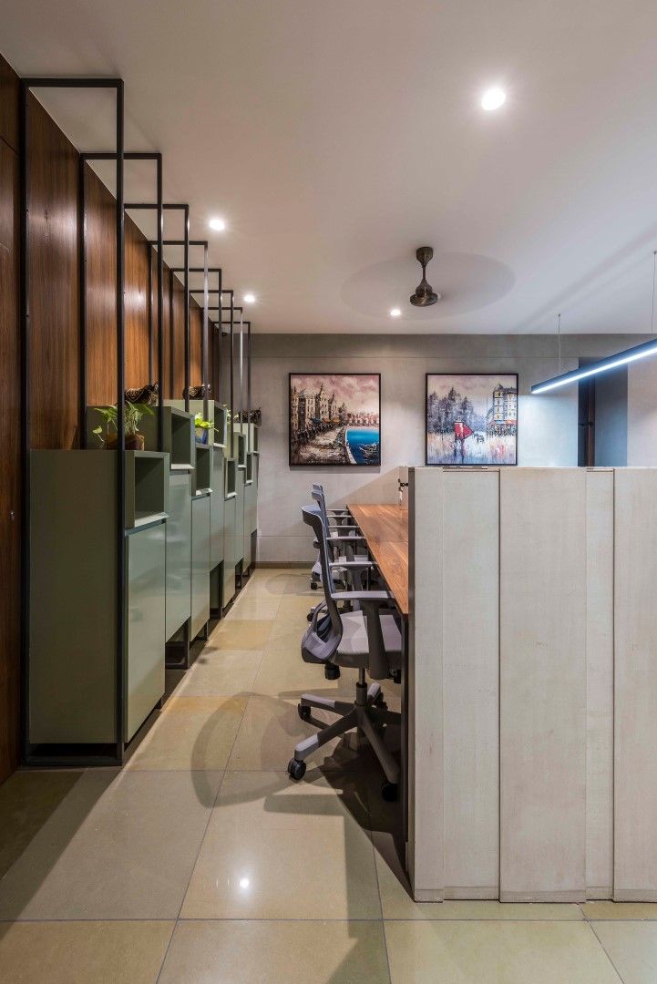 an office with wooden cabinets and black leather chairs in the center, along with two long desks on either side