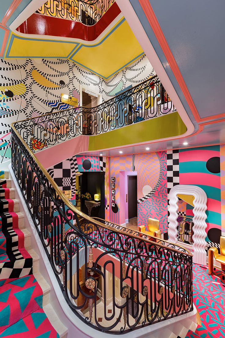 the stairs in this room are decorated with colorful wallpapers and geometric designs on them